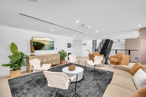 A modern interior with a reception desk, seating area, and staircase. - Dazzling 2BR Miami | Rooftop Pool & Co-Working (Miami)