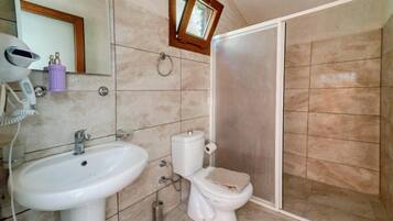 A bathroom with a sink, toilet, and shower.