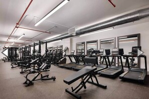 A gym with various exercise equipment, including treadmills and weight machines. - 10 Min Soho NYC Comfort Suite (Jersey City)