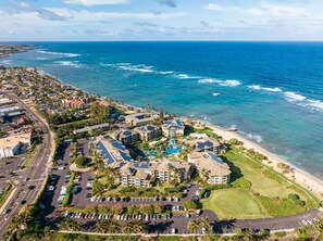 An aerial view of a coastal resort with multiple buildings, a parking lot, and a beach. - Waipouli C102 / 2 King Beds / AC  / Pool (Kapaʻa)
