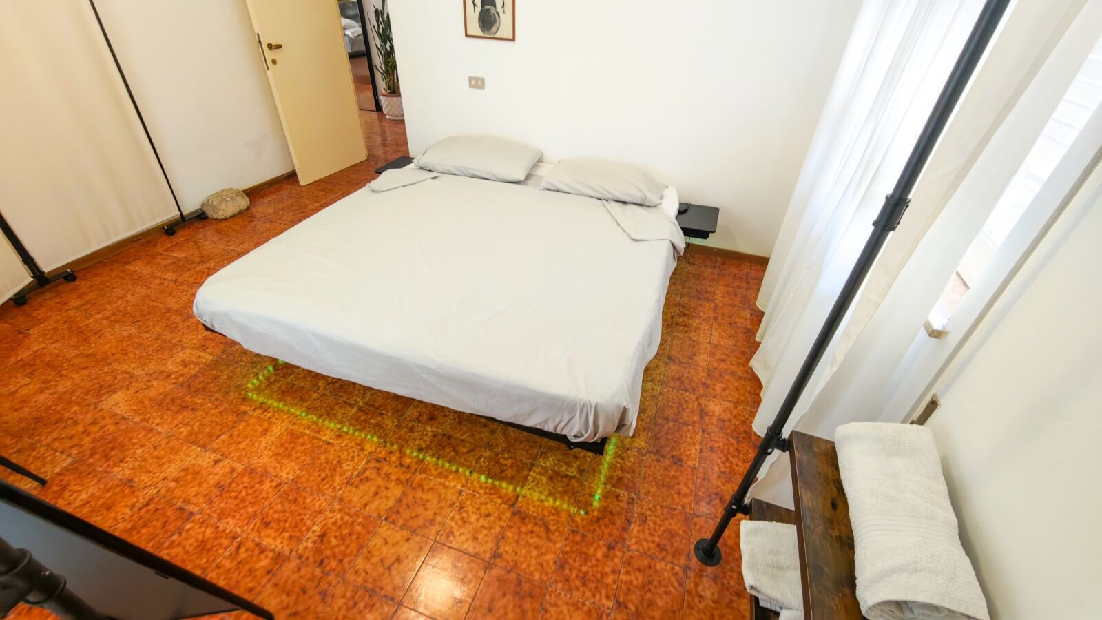 A room with a bed, a small table, and a window.