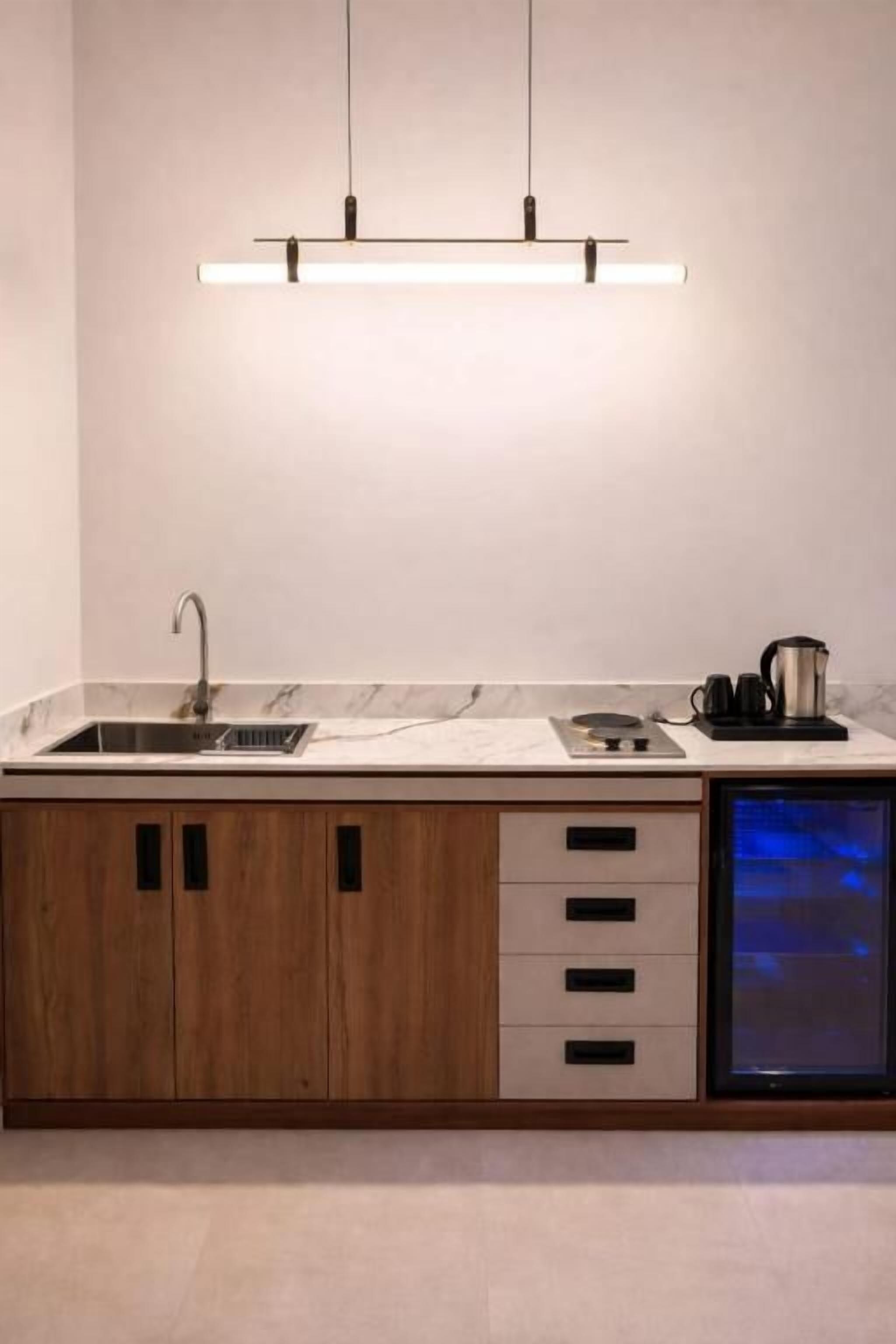 A modern kitchen with a built-in dishwasher, wooden cabinets, and a stainless steel sink.