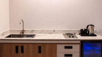 A modern kitchen with a built-in dishwasher, wooden cabinets, and a stainless steel sink.