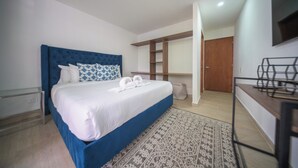 A bedroom with a large bed, a desk, and a wardrobe. - The Garden Mansion | 11 Bedrooms with Club Lounge•Jacuzzi•Olympic Pool•Maid•AC (Medellín)