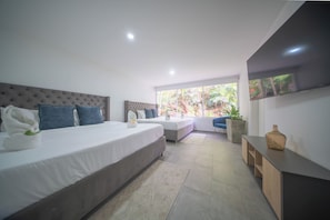 A modern hotel room with two beds, a large window, and a view of greenery. - The Garden Mansion | 11 bedrooms with a club lounge•Jacuzzi•Olympic Pool•Cleaning Lady•Air Conditioning (Medellín)
