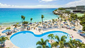 A resort with a large pool, beach area, and ocean view. - Prime location in Lowlands, Sint Maarten (Maho Bay)