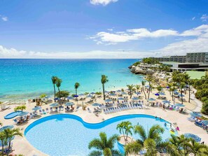 A resort with a large pool, beach area, and ocean view. - Prime location in Lowlands, Sint Maarten (Maho Bay)