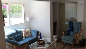 A living room with a sofa, armchair, and coffee table. - Spacious 4-bedroom home-sleeps 9 with AC in all rooms-3 minutes from the sea! (Çeşme)