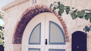A double door with a brick archway, a mailbox, and a number '12' sign on a building facade. - Spacious 4-bedroom home-sleeps 9 with AC in all rooms-3 minutes from the sea! (Çeşme)