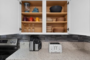 A kitchen with a built-in oven, a toaster, and a knife block. - Lander & Mt Rose Duo | Near Midtown & Downtown (Reno)