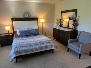 A bedroom with a bed, nightstands, a dresser, a chair, and a mirror. - Beautiful Townhouse 4 bedroom 3  bathroom in Fogelsville PA (Fogelsville)