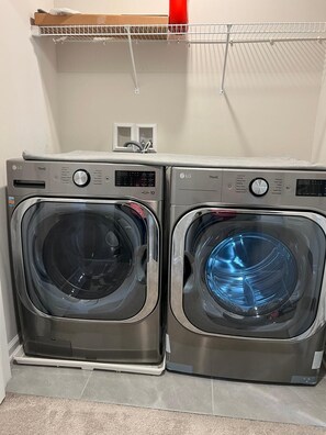 A laundry room with two front-loading LG ThinQ washers and dryers. - Beautiful Townhouse 4 bedroom 3  bathroom in Fogelsville PA (Fogelsville)