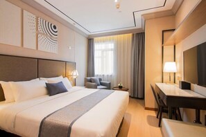 A hotel room with a large bed, a desk, a chair, and a TV. - Yitel Premium (Shanghai)