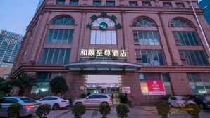 A hotel entrance with a large arched window and a sign above it. - Yitel Premium (Shanghai)