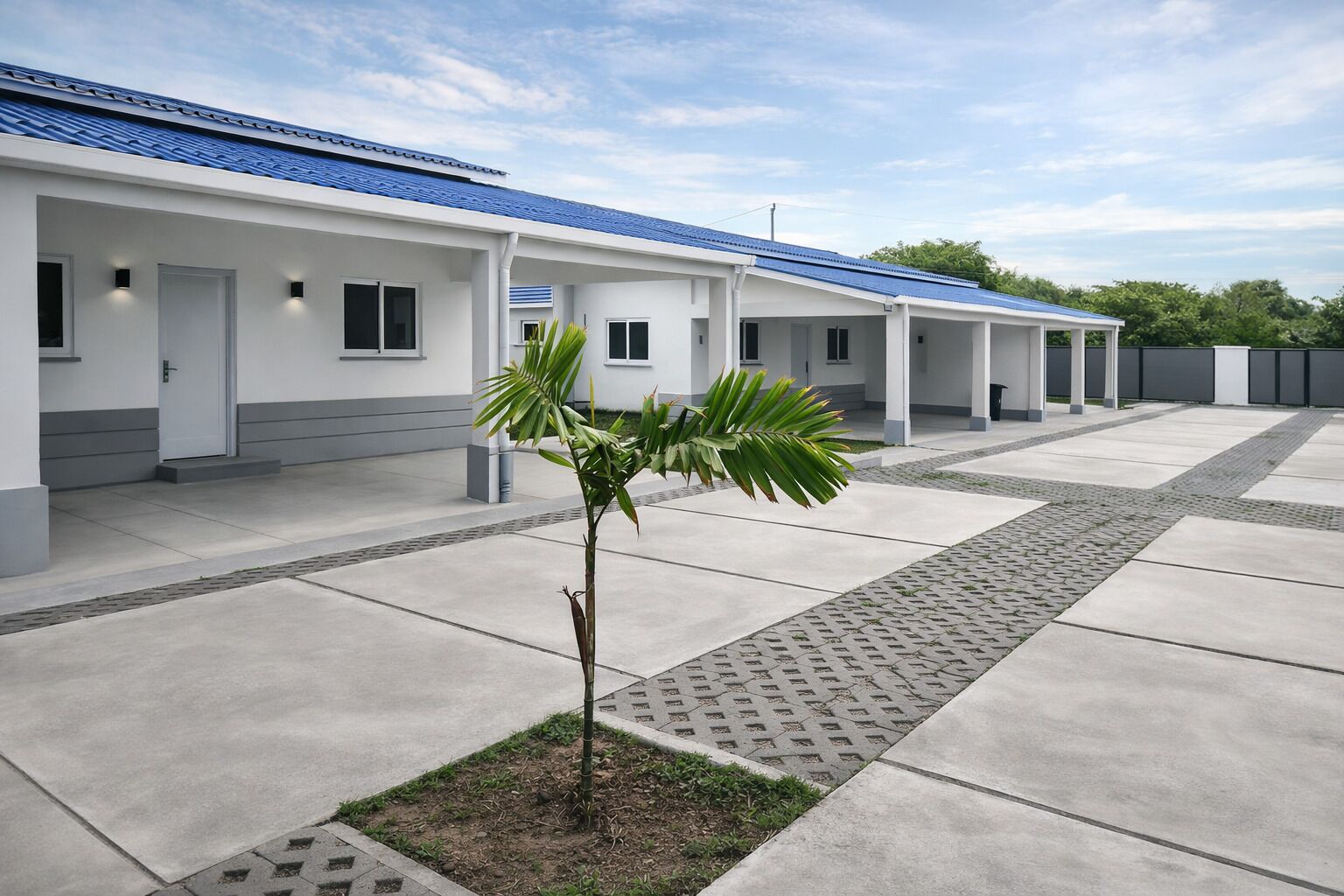 A modern building with a blue roof, a covered walkway, and a small palm tree.