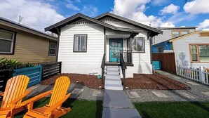 A single-story house with a front porch, a small staircase, and a pathway leading to the entrance. - North Park 3BR Furnished Rental—31-Night Minimum (San Diego)