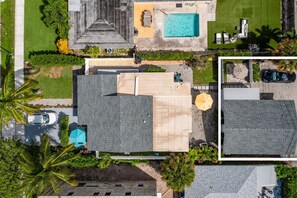 A residential area with a swimming pool, a covered patio, and a car parked on the street. - 237B Managed by Brampton Park (Delray Beach)