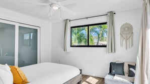 A bedroom with a bed, a window with curtains, a ceiling fan, and a dreamcatcher on the wall. - 1750 Managed by Brampton Park (Pompano Beach)