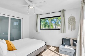 A bedroom with a bed, a window with curtains, a ceiling fan, and a dreamcatcher on the wall. - 1750 Managed by Brampton Park (Pompano Beach)