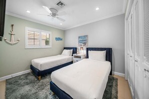 A bedroom with two beds, a ceiling fan, a window with blinds, and a painting on the wall. - 1650 Managed by Brampton Park (Pompano Beach)