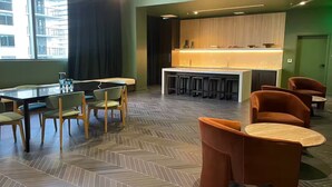 A modern hotel lobby with a bar area, seating arrangements, and a patterned floor. - Entire apartment in Miami – NEW (Miami)