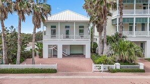 A two-story building with a balcony, a covered entrance, and a brick pathway. - Sea Attached: Private Pool (South Padre Island)
