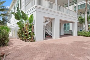 A white building with a covered outdoor area, a staircase, and a view of the sky. - Sea Attached: Private Pool (South Padre Island)