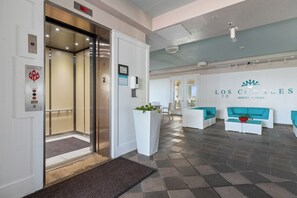 An elevator, reception area, and a lounge with a pool table. - 3BR, 4BA Gulf-view condo in South Padre Island. (South Padre Island)