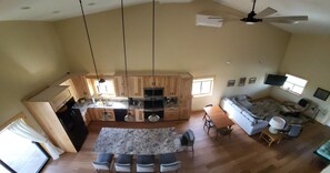 A spacious living area with a kitchen, dining table, and seating. - Shell Lake Getaway. Spacious 3-bedroom barndominium in nearby Beaver Brook (Shell Lake)