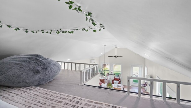 A spacious attic room with a large bean bag, a white ceiling, and a view of the living area below. - Thors Cottage at Hidden Gem Farm-Sleeps 5 (Spring Hill)