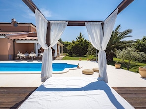 A poolside area with a pergola, a swimming pool, and outdoor furniture. - in Medulin mit Privatem Pool by Interhome (Medulin)
