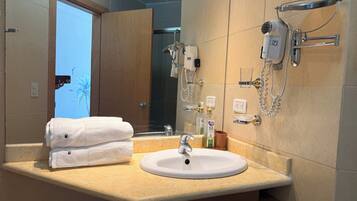 Shower, hair dryer, towels, toilet paper
