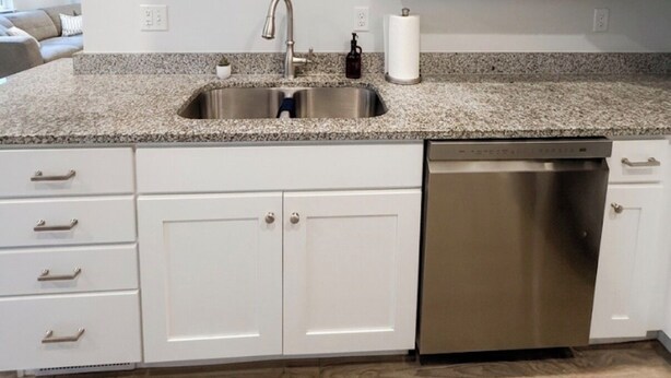 A kitchen with white cabinets, a stainless steel sink, and a dishwasher. - The Point Retreat, Theater, Firepit, Near I-15 (Bluffdale)