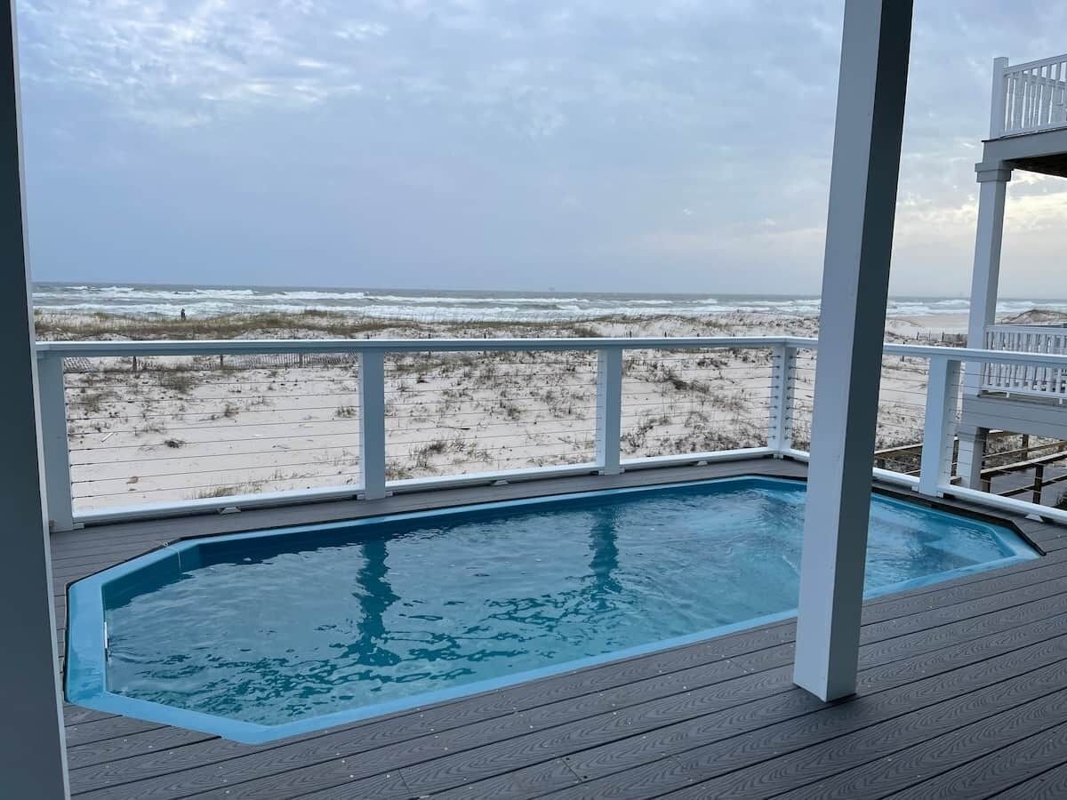 A pool with a view of the beach.