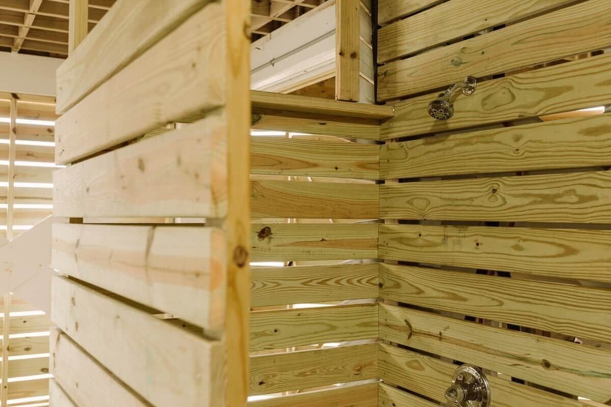 A wooden interior structure with horizontal beams and a metallic fixture.