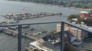 Eine Marina mit vertäuten Booten, eine Pier, die sich ins Wasser erstreckt, und Gebäude im Hintergrund.