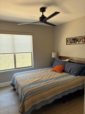 A bedroom with a bed, a ceiling fan, a window, and a wall-mounted lamp. - Winter in AZ!! Early bird pricing!! 1000.00 DOLLARS OFF for any 2 month stay!! (Scottsdale)