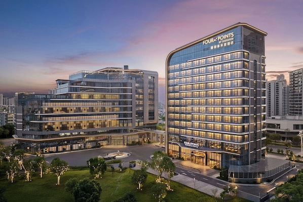 A modern hotel with multiple floors and a prominent signage.