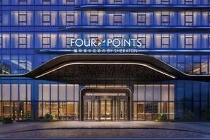 A hotel entrance with a modern design, featuring a glass facade and a sign that reads 'FOUR POINTS BY SHERATON'. - Four Points By Sheraton Fuzhou Changle (Fuzhou)