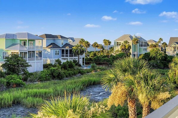 A coastal residential area with houses, a beach, and a stream.