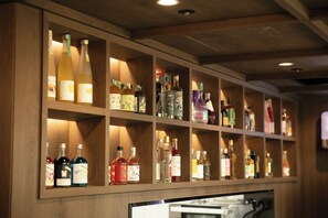 A bar area with shelves stocked with various bottles of liquor. - FIRST CABIN SEOUL MYEONGDONG (Seoul)