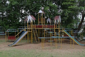A playground with slides and climbing structures. - Vits Kamats Resort (Silvassa)
