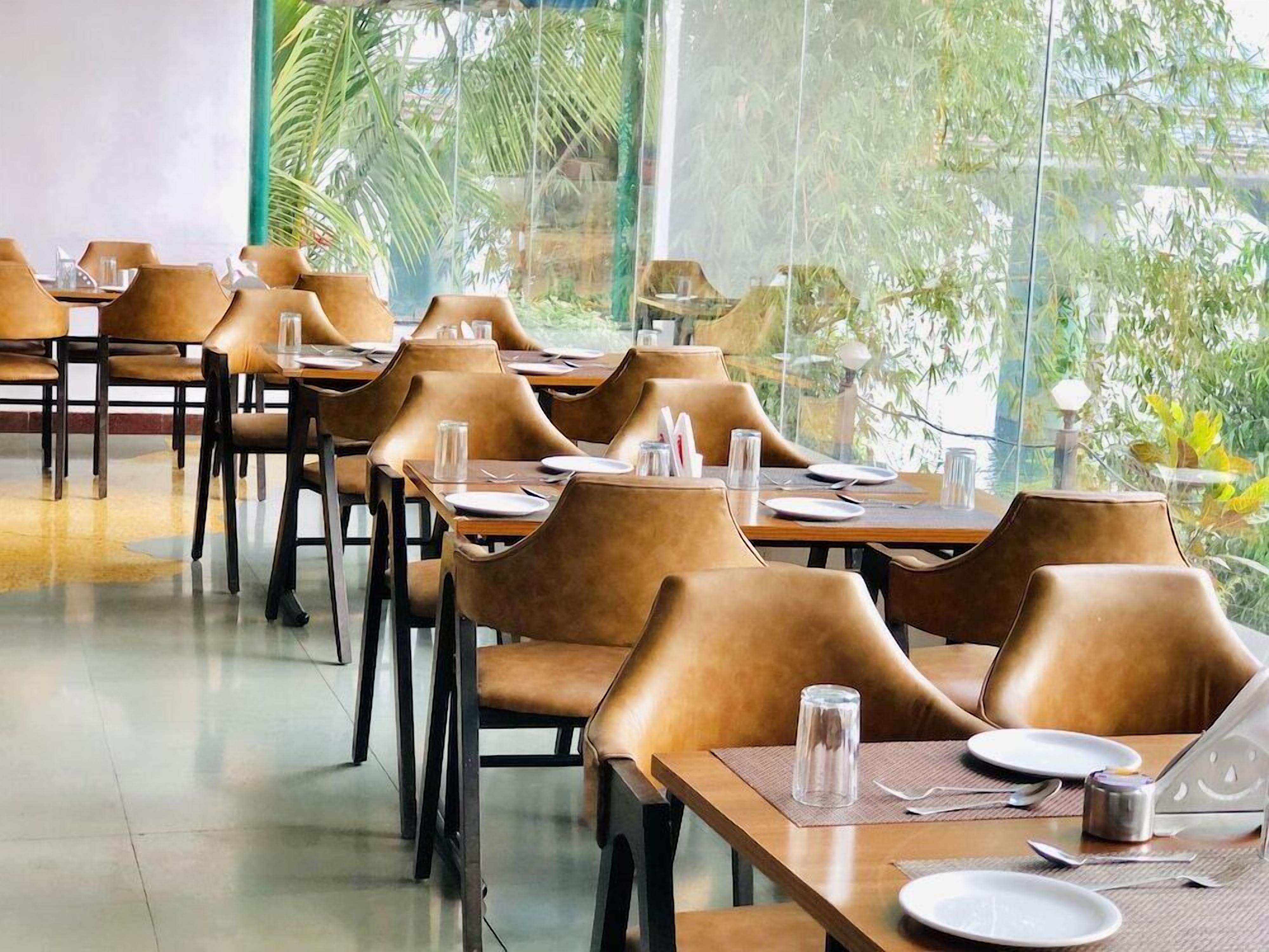 A restaurant with tables and chairs arranged for dining.