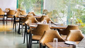 A restaurant with tables and chairs arranged for dining.