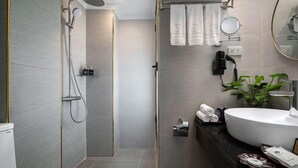 A modern bathroom with a walk-in shower, a large sink, and a mirror. - Bonsella Cozy Hotel (Hanoi)