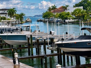 A marina with boats docked, wooden pilings, and a clear view of the water. - Luxury Bayfront Designer Retreat • Paddleboard • Stunning Sarasota Sunsets (Sarasota)