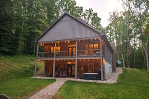 A two-story building with a balcony, a hot tub, and a sign that reads 'GO TO THE TRIBE.' - Scout's Retreat (Green Township)