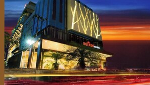 A hotel with a modern facade, a prominent sign, and a well-lit entrance. - Borneo Hotel (Pontianak)