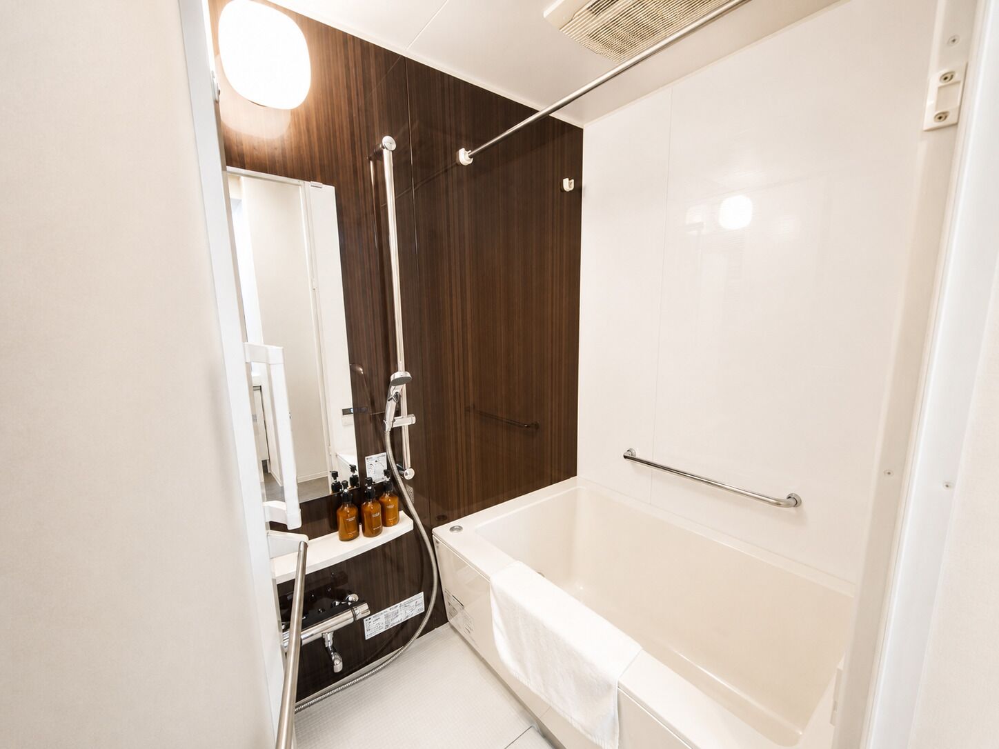 A modern bathroom with a bathtub, a shower, and a vanity with a mirror.