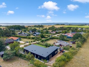 A residential area with houses, a large building, and wind turbines in the distance. - "Hubertina" - 900m from the sea by Interhome (Ebeltoft)